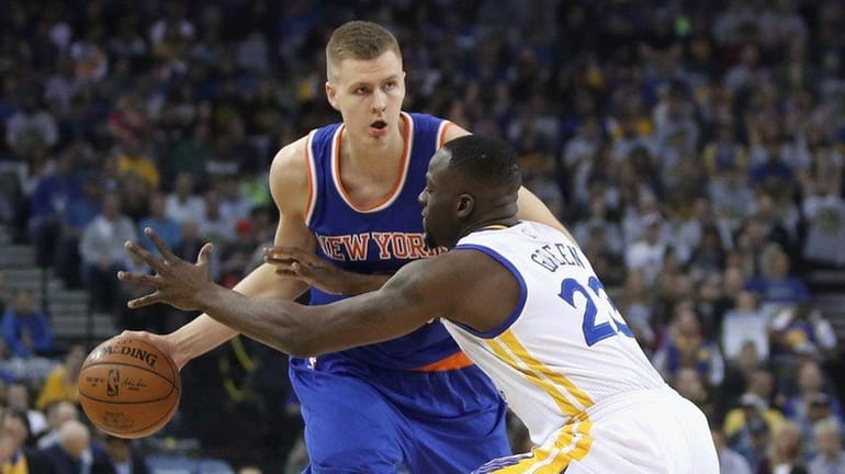 Draymond Green tries to steal ball from Kristaps Porzingis during...