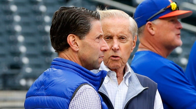 Fred Wilpon (R) talks with Jeff Wilpon during batting practice...