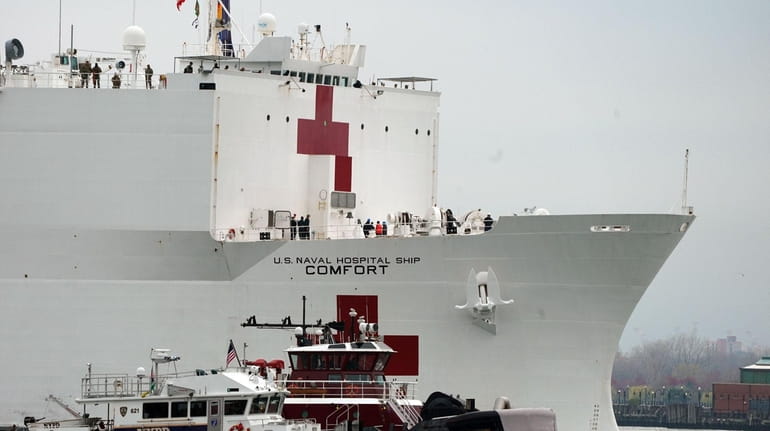 The USNS Comfort medical ship moves up the Hudson River...