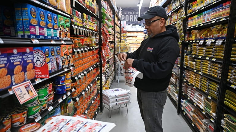 Store manager Fredy Delgado at work at Compare Foods.
