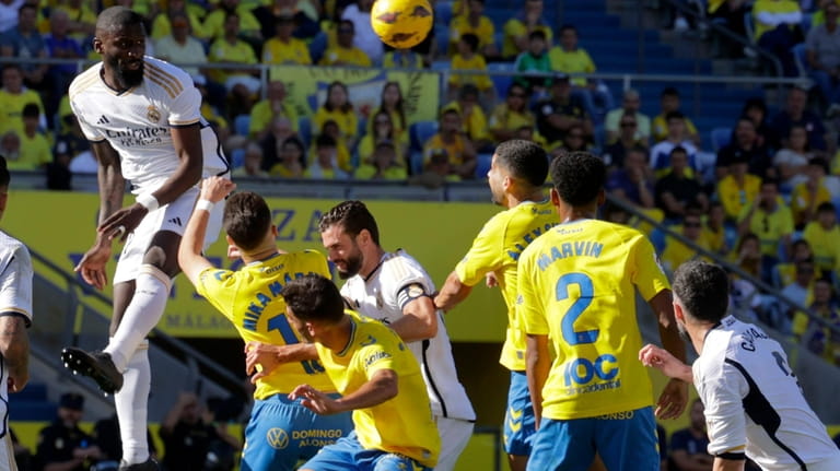 Real Madrid's Antonio Rudiger jumps for the ball during a...