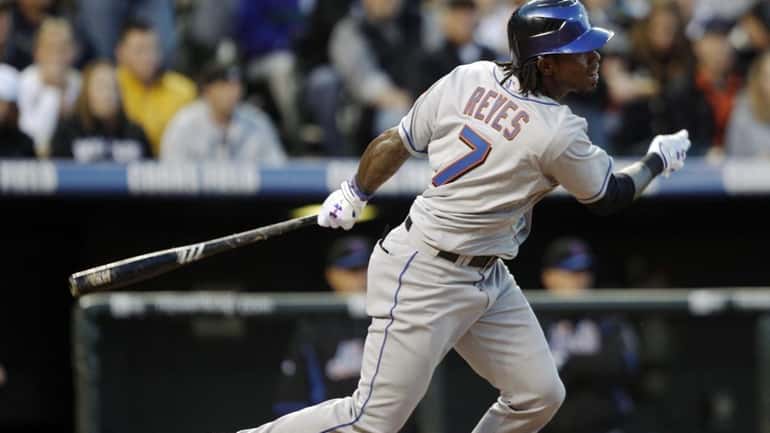 New York Mets' Jose Reyes follows the flight of his...