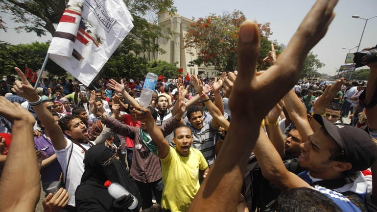 Egyptians shout anti-military slogans during a protest in front of...