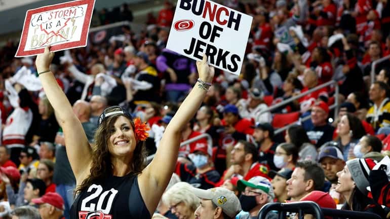 A Carolina Hurricanes fan cheers during the third period in...