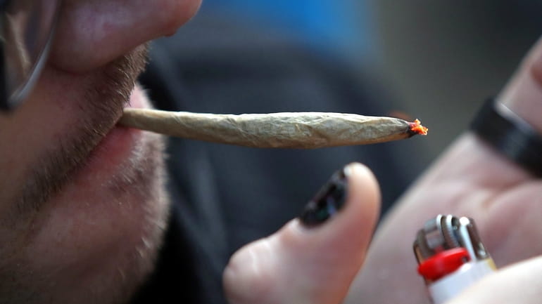 A recreational marijuana smoker on April 14, 2020 in the...