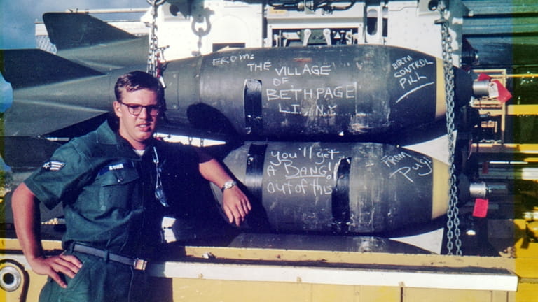 Sgt. Chris Suhr, of Massapequa Park, poses beside a B-52 bomb...