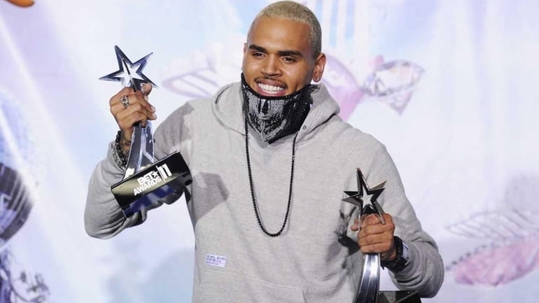 Singer Chris Brown poses in the press room at the...