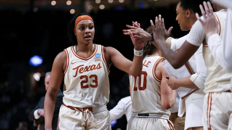 Texas forward Aaliyah Moore (23) celebrates with teammates after the...