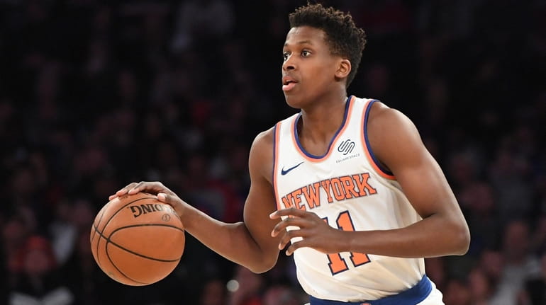 Knicks guard Frank Ntilikina dribbles the ball up court against...