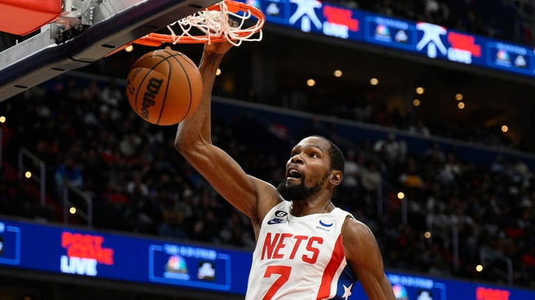 Nets forward Kevin Durant (7) dunks past Washington Wizards forward...