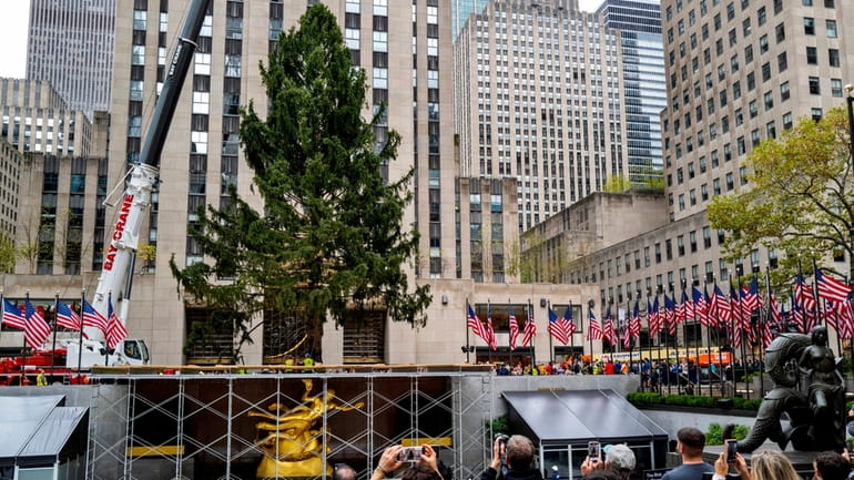 Visitors watch as the 2022 Rockefeller Center Christmas Tree is...