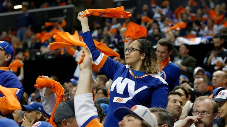 Fans cheer during the first period of the Islanders' Game...