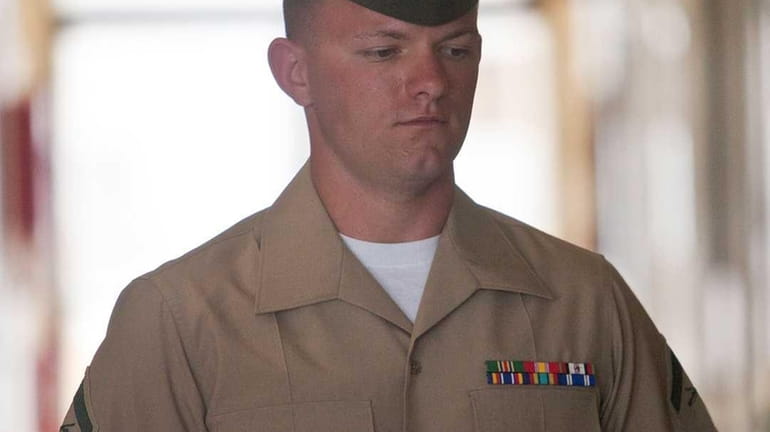 Lance Cpl. Jacob D. Jacoby enters the courtroom of the...