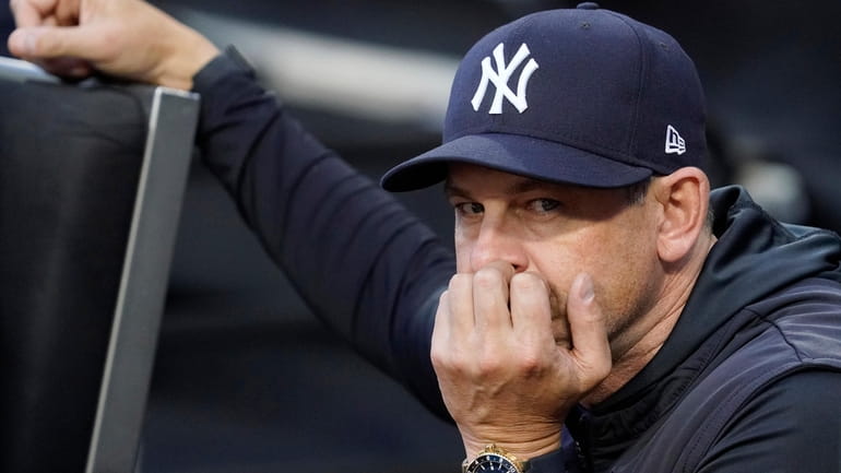 ankees manager Aaron Boone looks on before a baseball game...
