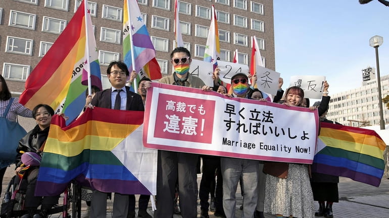 Plaintiffs and others shows a banner in front of Sapporo...