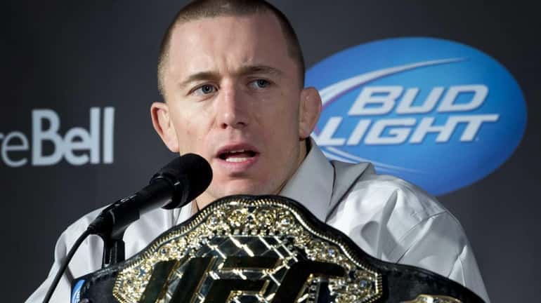 Welterweight UFC Champion Georges St-Pierre responds to a question during...
