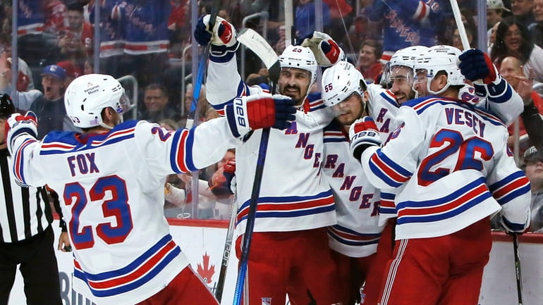 Rangers center Mika Zibanejad, second from right, celebrates with Adam...