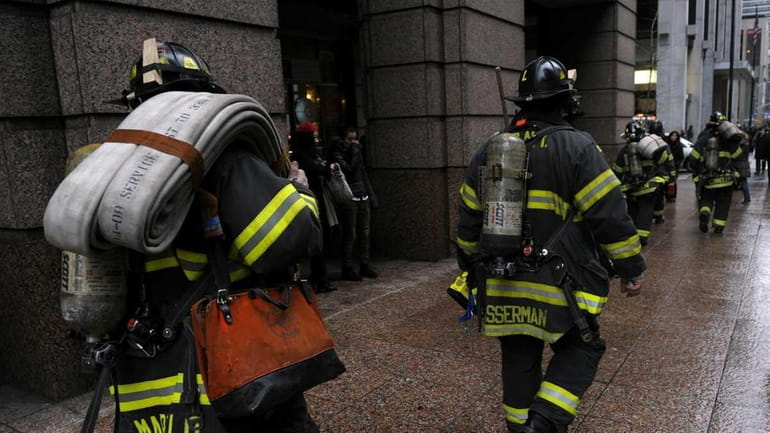 New York City Fire Department responders leave the Israeli Bank...