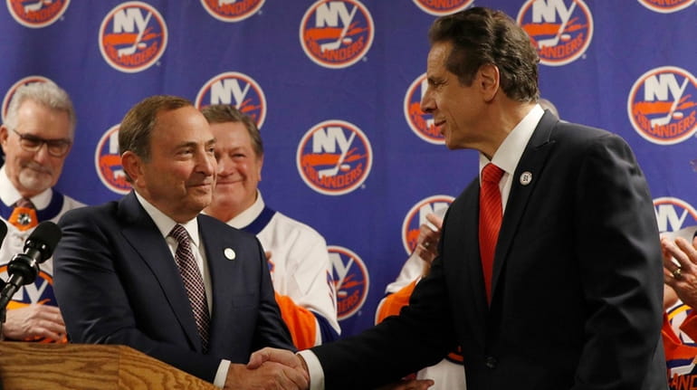 NHL commissioner Gary Bettman and governor Andrew Cuomo shake hands...