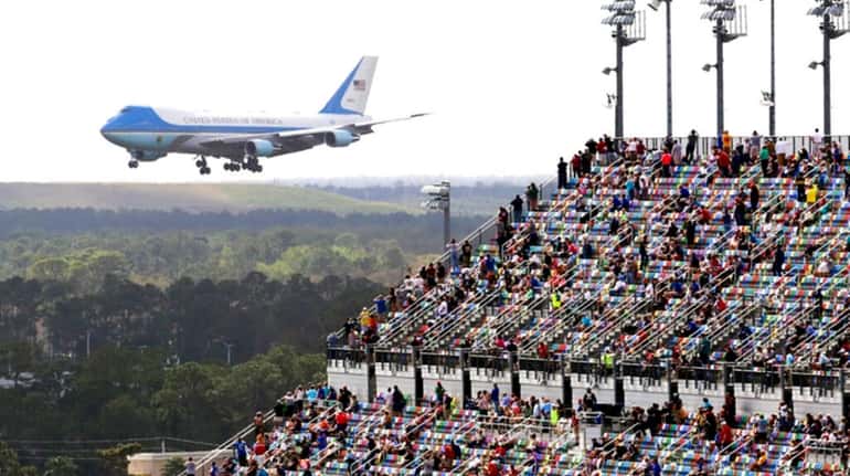 Race fans watch from the grandstands as Air Force One...