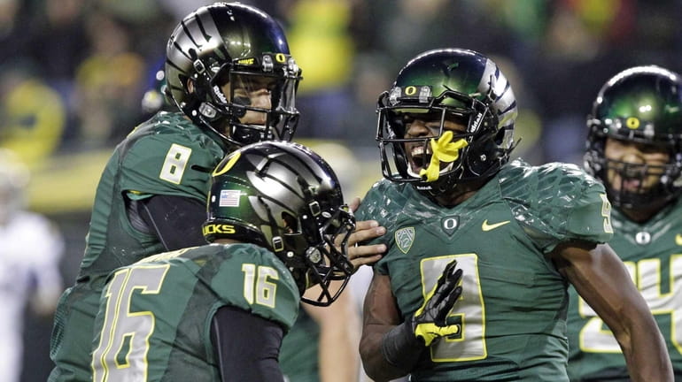 Oregon running back Byron Marshall, right, celebrates his touchdown with...