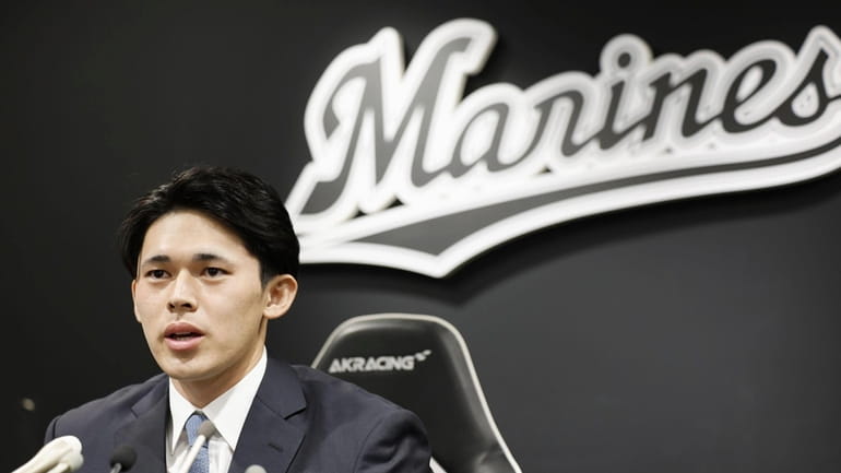 Japan's Lotte Marines pitcher Roki Sasaki speaks at a press...