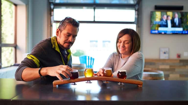 Ricardo and Michele Pacheco enjoy a beer flight, Six Harbors...