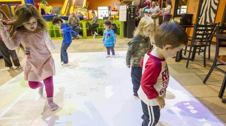 Kids play on "Motion Commotion" at Safari Adventure. (Dec. 4,...