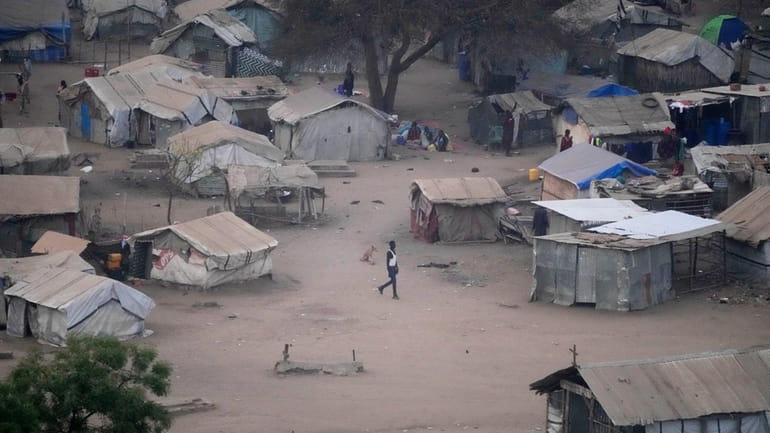 People stand by their houses in Juba, South Sudan, on...