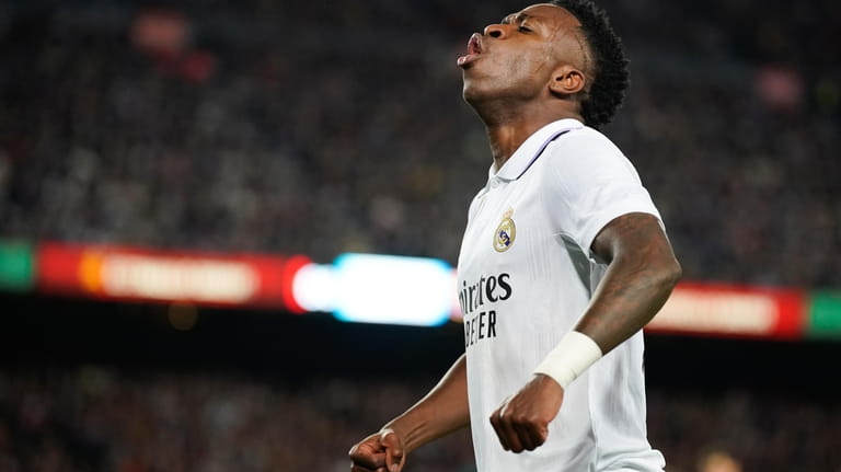 Real Madrid's Vinicius Junior celebrates after his team's first goal...
