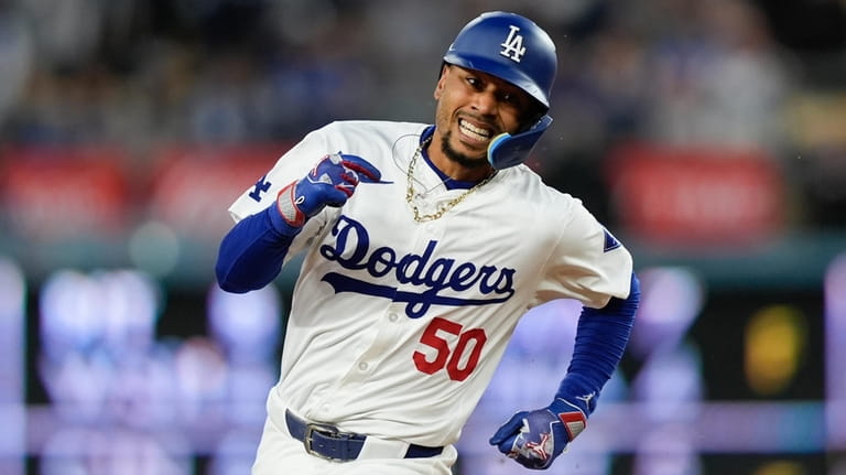 Los Angeles Dodgers' Mookie Betts runs to third after hitting...