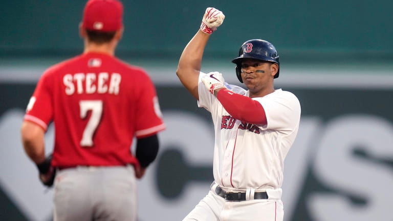 Boston Red Sox's Rafael Devers celebrates his RBI double during...