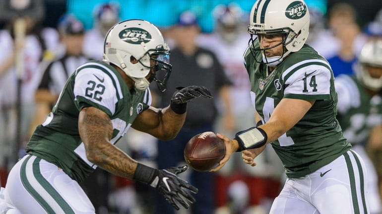 New York Jets quarterback Ryan Fitzpatrick (14) hands off to...