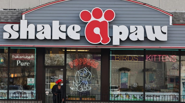 A person attempts to enter the shuttered Shake-A-Paw in Hicksville...