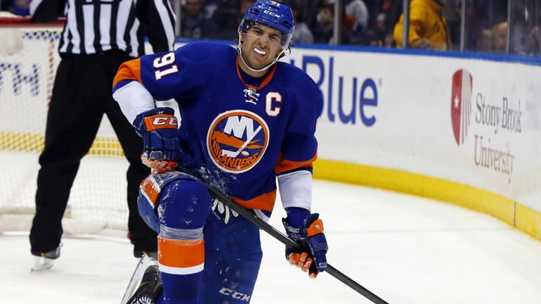 John Tavares of the Islanders grimaces after falling into the...