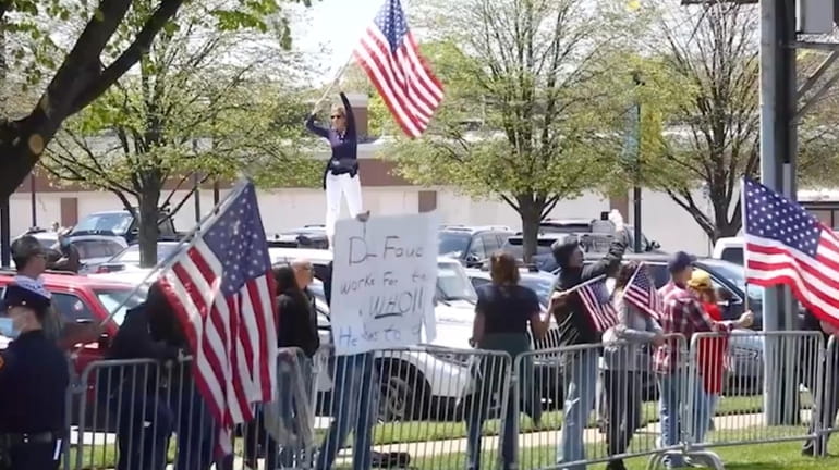 This screenshot from video shows a recent protest in Commack,...