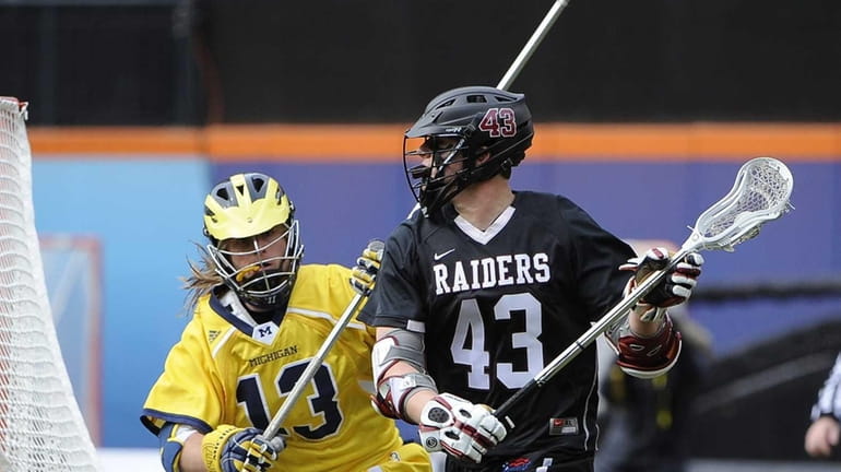 Colgate attacker Ryan Walsh, right, drives the ball from behind...