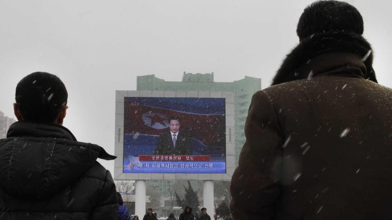 On a large television screen in front of Pyongyang's railway...