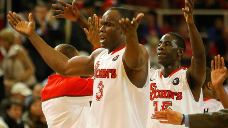 St. John's God'sgift Achiuwa and Sir'Dominic Pointer celebrate as they...