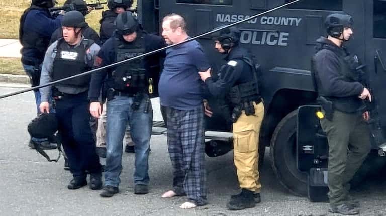 Paul Carey is arrested in front of his Massapequa home Wednesday,...
