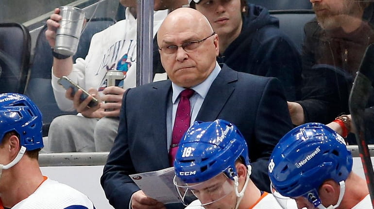 Islanders head coach Barry Trotz looks on from the bench...