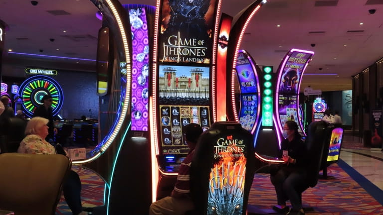 Gamblers play slot machines at the Hard Rock casino in...