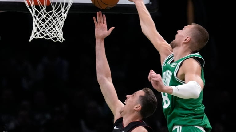Boston Celtics center Kristaps Porzingis blocks a shot by Miami...