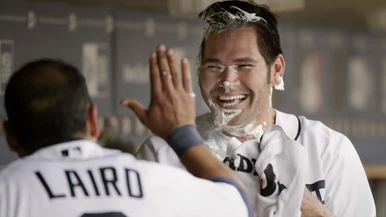 Detroit's Johnny Damon, right, laughs after getting a pie in...