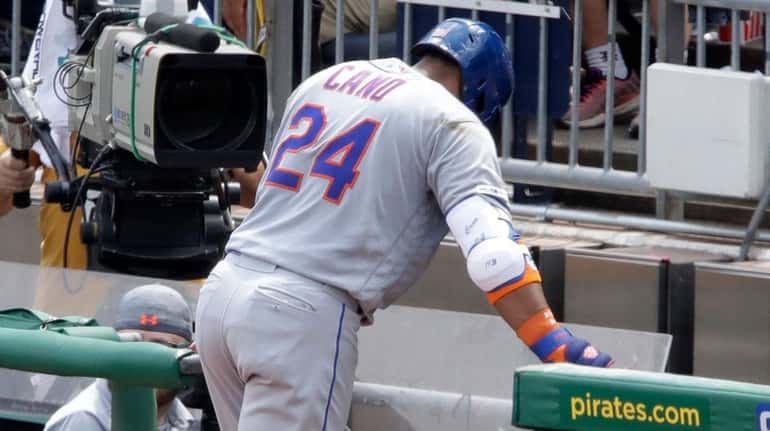 Mets second baseman Robinson Cano makes his way to the dugout...