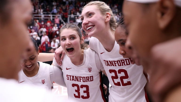 Stanford seniors Cameron Brink (22) and Hannah Jump huddle with...