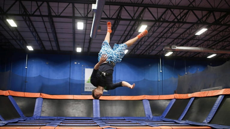 Taylor Pineda of Bay Shore, inverts himself on a trampoline...