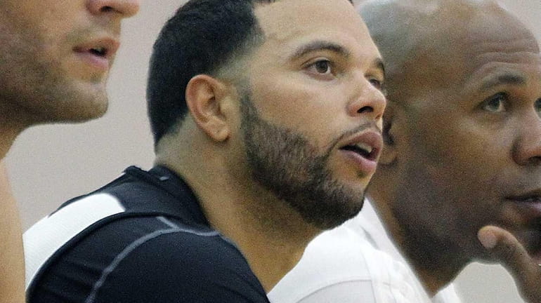 Deron Williams sits on the bench during practice at the...