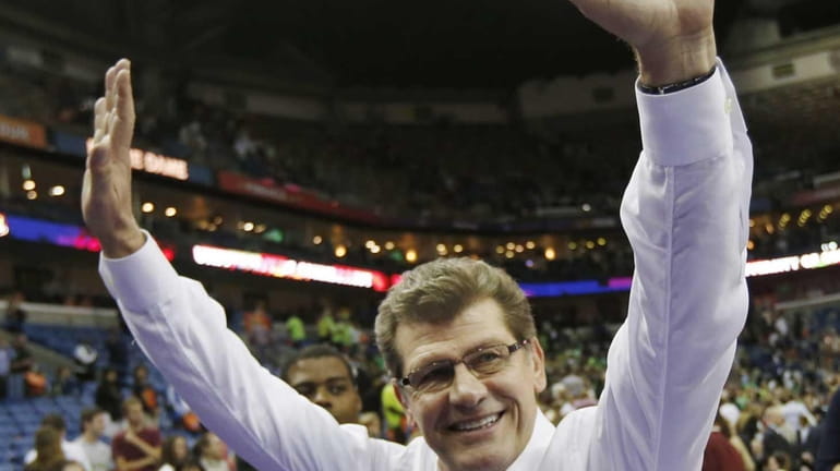 Connecticut head coach Geno Auriemma waves to fans after the...