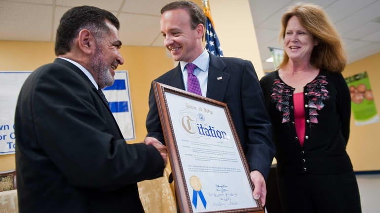 El Salvador Consulate General Dagoberto Torres, left, receives a certificate...